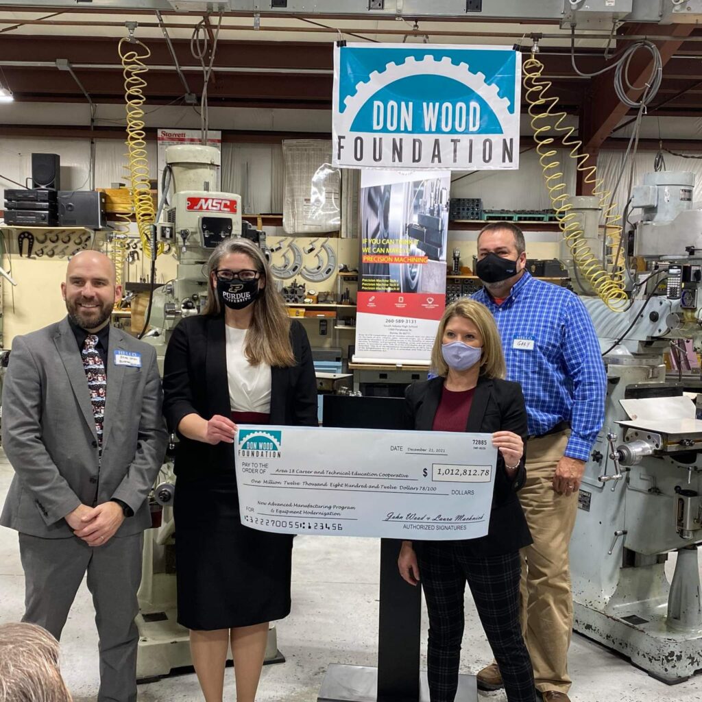 Danielle Rich, Don Wood Foundation Program Officer, and Gary Gatman, Don Wood Foundation Trustee for the Don Wood Foundation presents a check to the Area 18 CTE Coopeartive Director Brittany Kloer and Dr. Brad Yates, Area 18 LEA.
